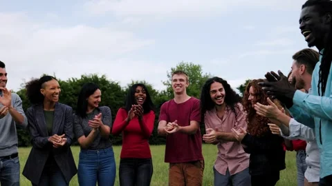 Multiracial group of people celebrating, clapping hands at park city in summer   Stock Footage 280435624