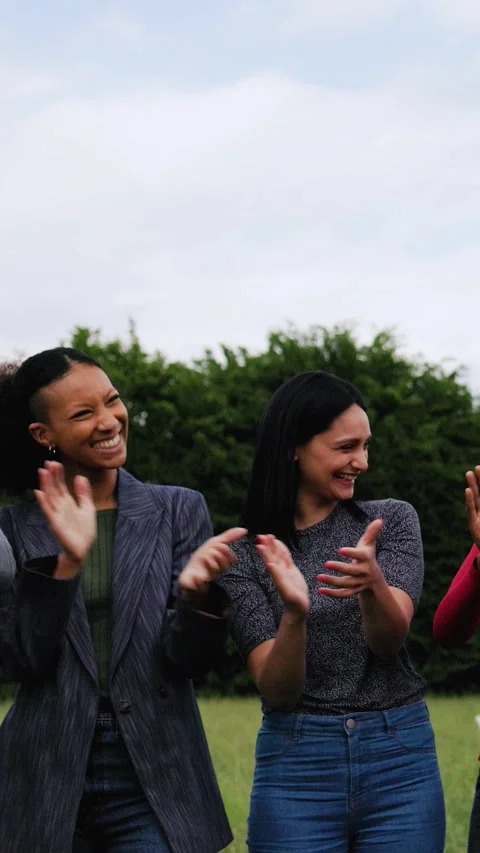 Multiracial group of people celebrating, clapping hands at park city in summer  Stock Footage 286218425