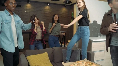 Multiracial group of people is dancing drinking beer having fun at home party Stock Footage 124042485