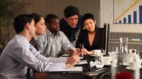 Multiracial group working and looking at screen. Black man leading. Smiling. 動画素材 40692848