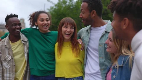 Multiracial group of young friends hugging each other having fun in city street Stock Footage 249905338