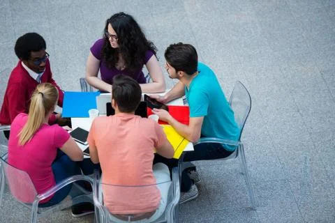 Multiracial group of young students studying together. High angle shot of young Stock Photos