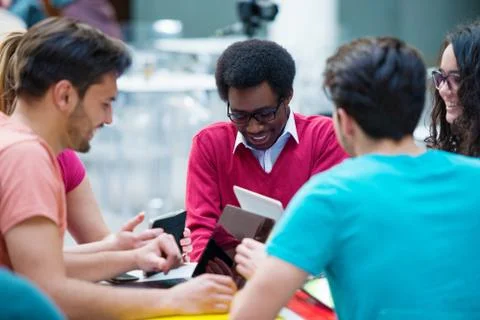 Multiracial group of young students studying together. High angle shot of young Stock Photos