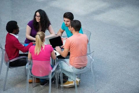 Multiracial group of young students studying together. High angle shot of young Stock Photos