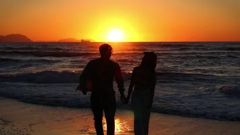 Multiracial Hispanic couple walking hand in hand towards the camera during .. Stock Footage 273922003