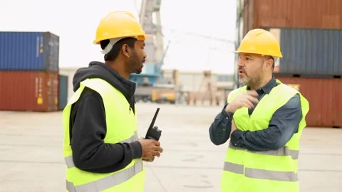 Multiracial industrial operators working inside international containers port Stock Footage 182584760