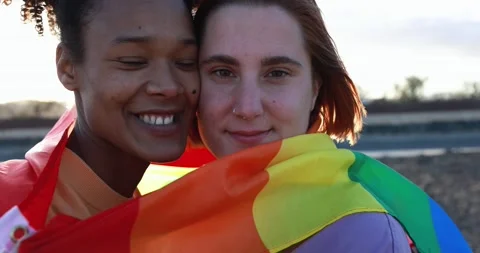Multiracial lesbian couple having tender moment outdoor Stock Footage 170604329