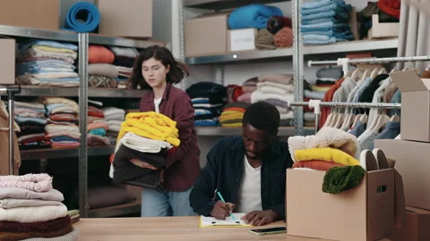 Multiracial man making notes while his female caucasian colleague putting Stock Footage 227517751