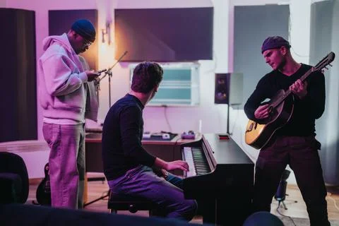 Multiracial musicians collaborating in a creative recording studio environment Stock Photos