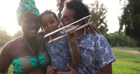 Multiracial parents having playful time with son at city park - Family love Stockbeeldmateriaal 170004215
