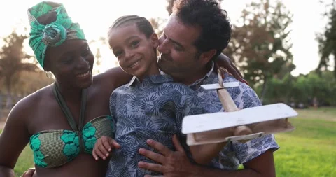 Multiracial parents having playful time with son at city park - Family love Stock Footage 170004256