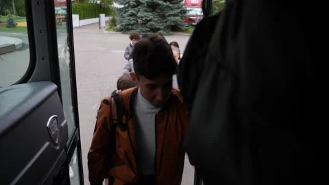 Multiracial pupils climbing steps getting on bus Video stock 169656118