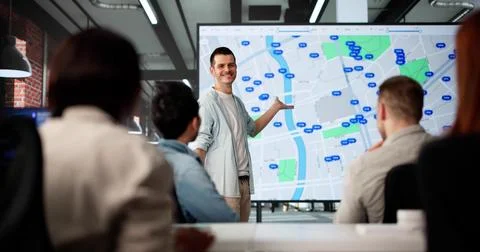 Multiracial Real Estate Agent Using Computer Map For Listing Search Fotos de archivo