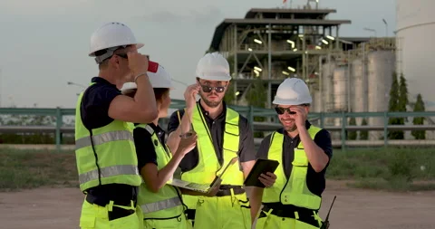 Multiracial refinery engineer adjusts protective eyewear beside technician Stock Footage 335606798