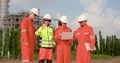 Multiracial refinery team stands with laptop and sample flask, smiling after Stock Footage 337392541