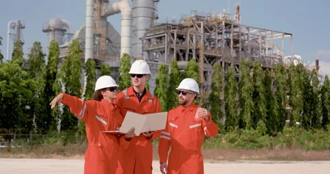 Multiracial refinery team walks through field with laptop and sample flask, Stock Footage 344393877