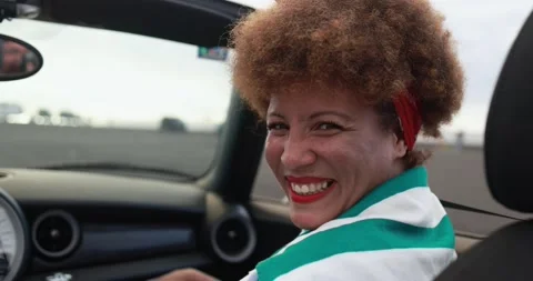 Multiracial senior couple having fun inside convertible car Видео 153403157