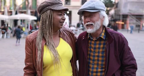 Multiracial senior couple having fun outdoor with city in background Stock Footage 174241424