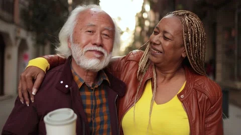 Multiracial senior couple having fun outdoor - Travel, elderly people concept Stock Footage 177944866