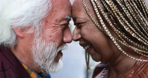 Multiracial senior couple having tender moment together outdoor Stock Footage 174242129