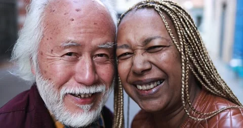 Multiracial senior couple smiling on camera outdoor Stock Footage 174243235
