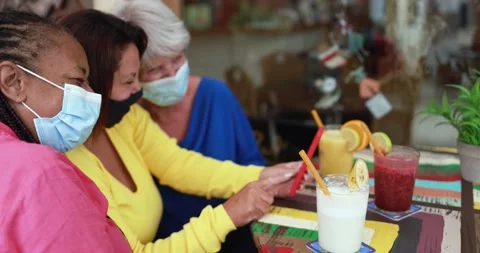 Multiracial senior women using mobile phone while wearing safety face mask Stock Footage 162230662