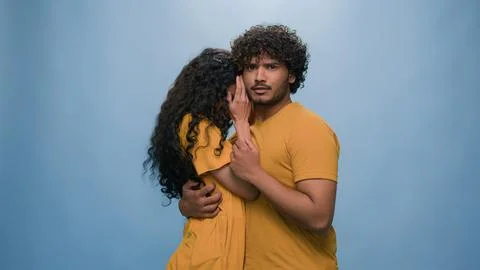 Multiracial shocked scared afraid couple amazed shocked Hispanic woman hiding Stock Photos