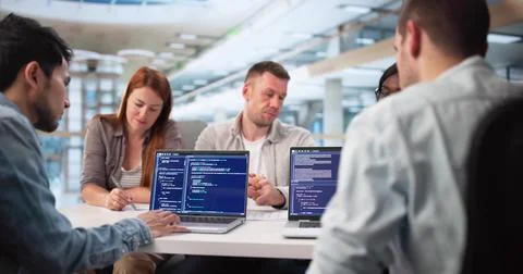 Multiracial Software Engineers Collaborate On Coding Project For Tech Company Stockfoto's