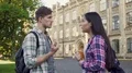 Multiracial students discussing test near campus, male and female talking HD Footage