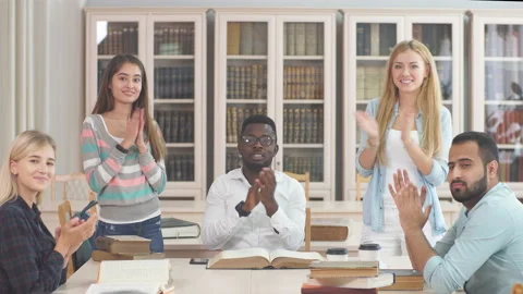 Multiracial students having fun in library while preparing for exams. Stock Footage 98642496