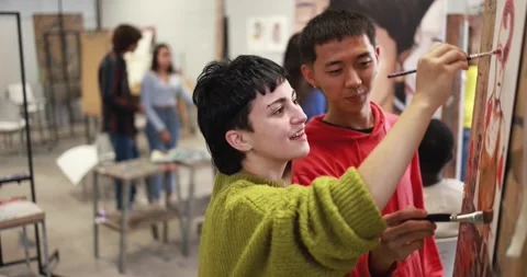 Multiracial students having fun painting inside art room class at university Видео 168623528