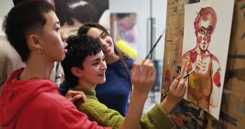 Multiracial students painting together inside art classroom at university Видео 168623694