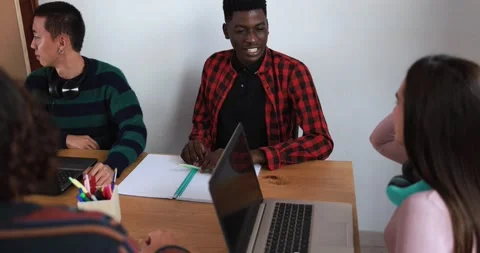 Multiracial students reading books and using laptop Stock Footage 164378378