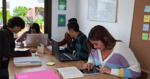Multiracial students reading books and using laptop while studying Stock Footage 164378449