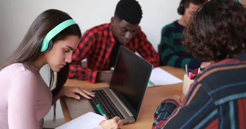 Multiracial students studying together inside library Stock Footage 164377889