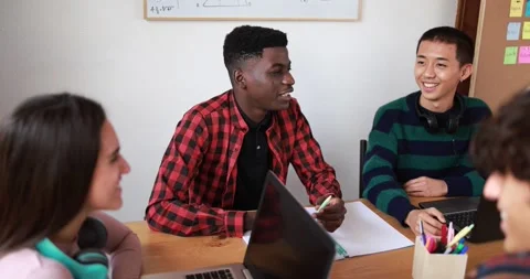 Multiracial students studying together inside library Video stock 164377970
