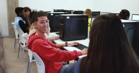 Multiracial students talking together inside computer classroom at university Stock Footage 168622522