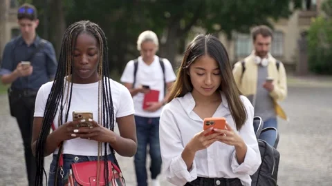 Multiracial students using cellphones during walk Vídeo Stock 163283240