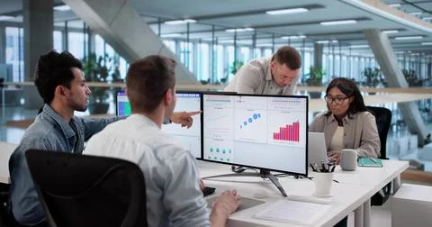 Multiracial Team Analyzing Performance Data On Computer Dashboard Screen Stock Photos