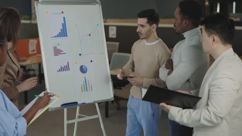 Multiracial team listening speaker presentation in office Stock Footage 211364226