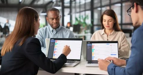 Multiracial Team Meeting To Discuss Support Tickets And System Downtime Stock Photos
