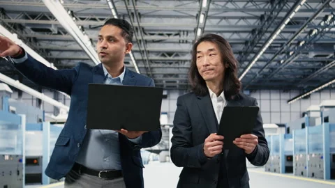 Multiracial team of microchip factory managers studying on manufacturing gear Stock Footage 333392536