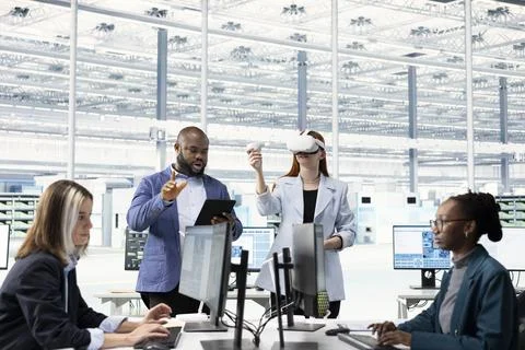 Multiracial team tests microchip electronics prototypes using VR, brainstorming Stock Photos