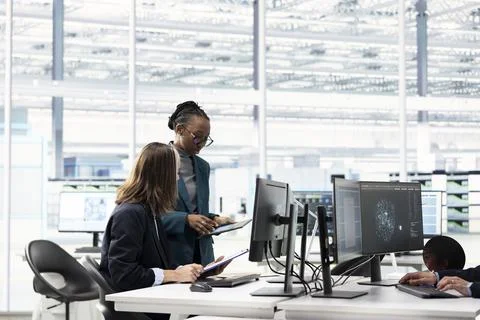 Multiracial team using AI machine learning to design complex PCB layout Stock Photos