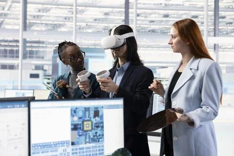 Multiracial technicians using VR headset to do microchip yield enhancement Stock Photos