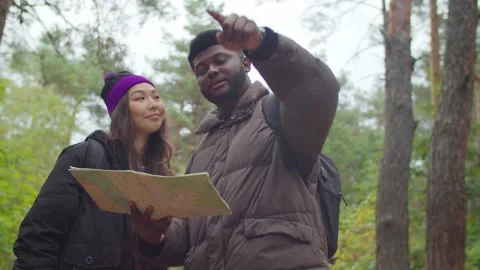 Multiracial tourists on trek navigating with map Stock Footage 141800113