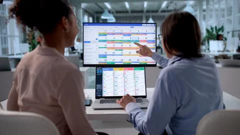 Multiracial Women Efficiently Using Agile Project Management Software In Offi Stock Photos