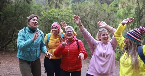 Multiracial women having fun dancing during trekking day into the woods Video stock 164377412