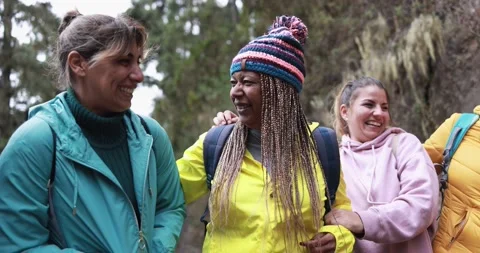Multiracial women having fun during trekking day into the woods 動画素材 164377313