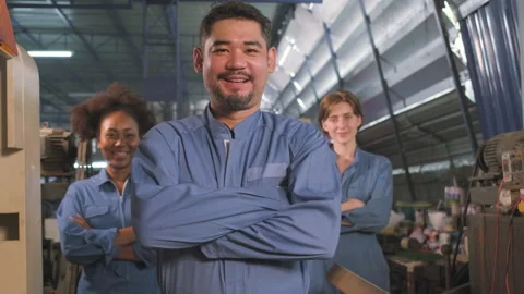 Multiracial workers collaborate and express happy work in a mechanical factory. Video stock 198783758